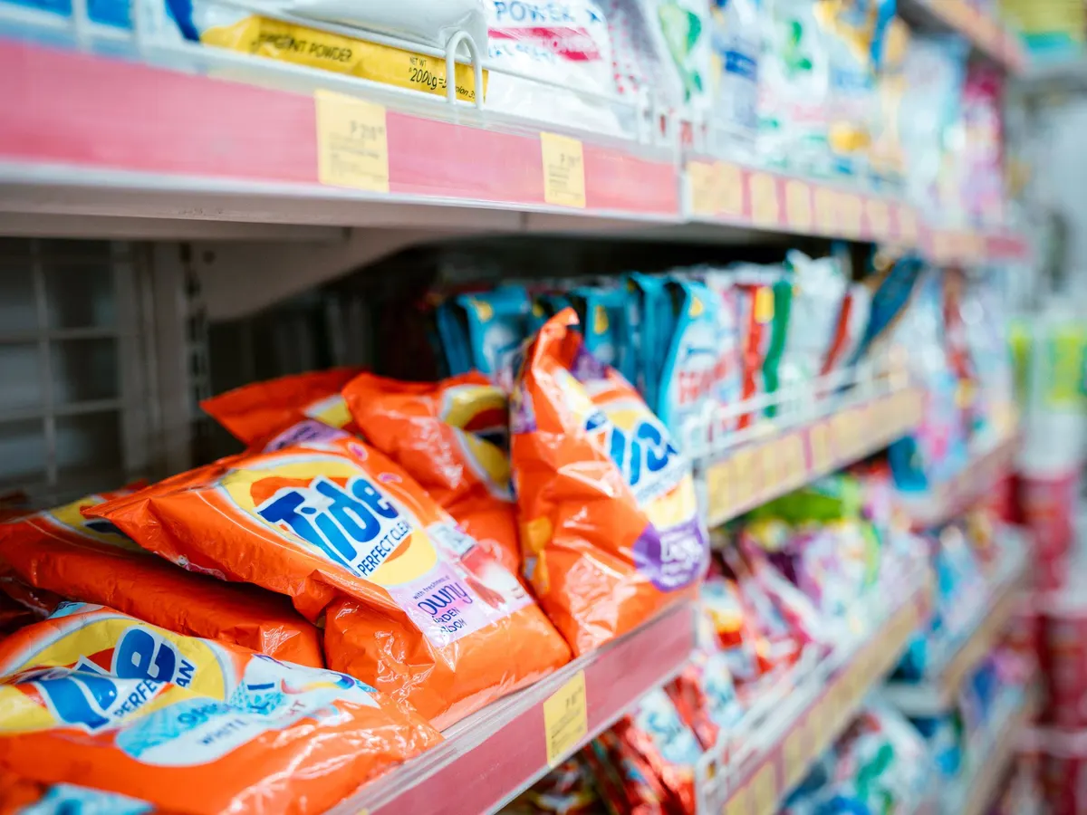 Store shelves stocked with laundry detergent packages