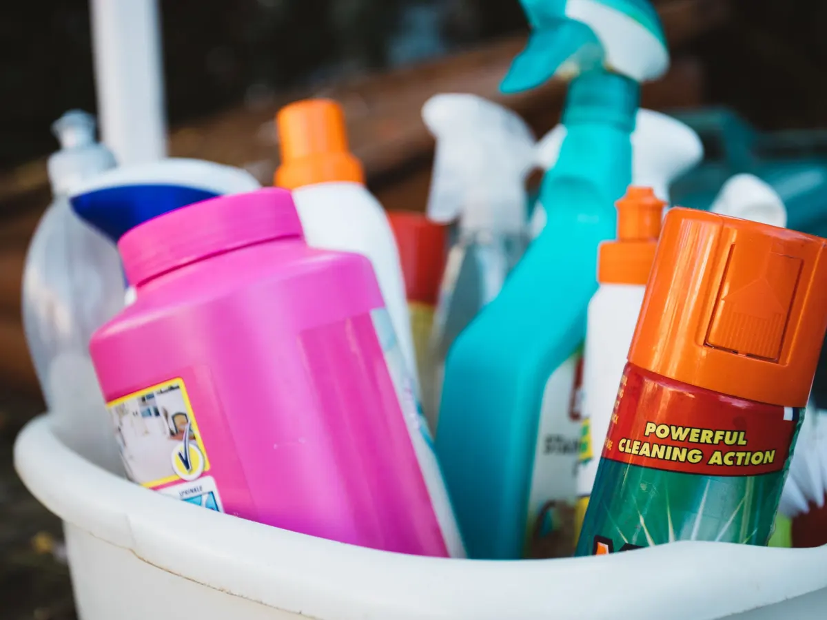 Basket filled with colorful cleaning product bottles